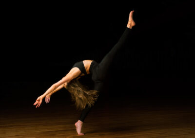 Mark Wildsmith Sheffield’s commercial food photographer at Wildsmith.photography in Sheffield. Ex Royal Navy chef with a history of fine dining. Now as a specialist food photographer bringing all his years of experience working in commercial kitchens. Holly Brown kicking her leg high and flowing hair, blackened background with dancer popping out of the image.
