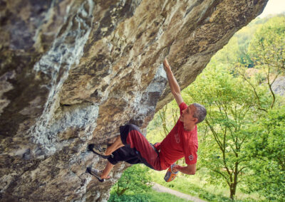 elite climber free climbing in the derbyshire dales. No ropes attached and its a long way down. huge amount of power to weight ratio. Unbelievable risk to life and limb but with strength and practice a skill made to look easy.